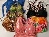 several different types of women ' s swimsuits laid out on a white surface