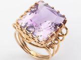 an amethorate and gold ring with a square cut amethorate surrounded by filigree