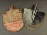 two shovels sitting next to each other on a table