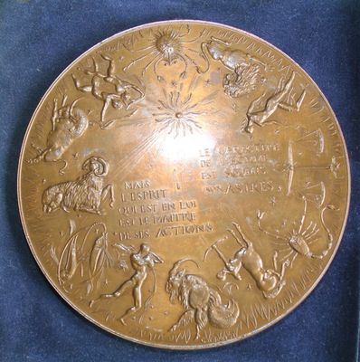 a gold plate with a picture of people and animals on it
