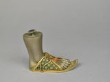 an image of a gold shoe with a blue stone in it
