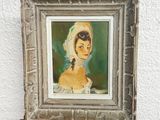 painting of a woman in a white dress on a wooden easel