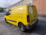 a yellow van that is parked in a parking lot