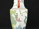 a white vase with a red handle on a black background