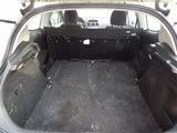 the back of a car with the trunk open and the seats down