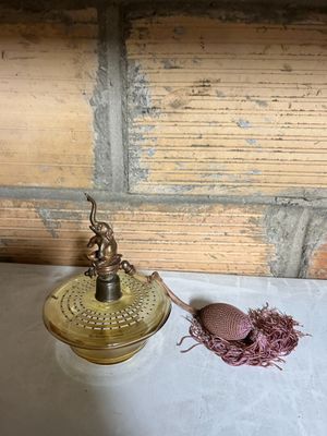 a small lamp that is on a table next to some thread