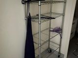 a coat rack with a coat hanger and an umbrella