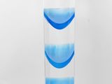 un grand vase en verre avec un socle bleu sur fond blanc