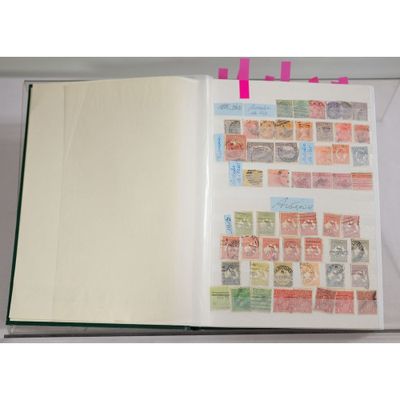 an open book with stamps on it sitting on top of a table