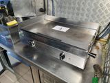 stainless steel counter top with two burners on it in a commercial kitchen