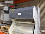 a machine that is sitting on a shelf in a warehouse