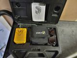 a black case with a yellow item in it