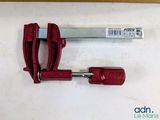 a red clamp that is sitting on a table