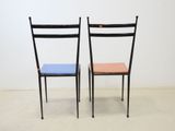 two black chairs with a blue seat and a red seat
