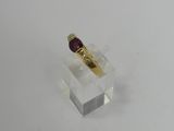 a close up of a gold ring with a red stone