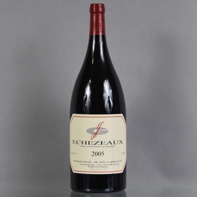 an image of a bottle of red wine sitting on top of a table