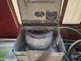 a box with a machine inside of it on the floor