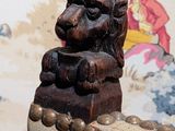 a statue of a lion sitting on top of a chair