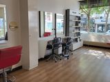 an image of a salon with a lot of chairs