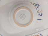 a white plate with a blue border and flowers on it