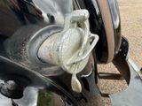 a close up of a metal object on the side of a car