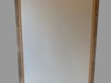 a picture of a mirror hanging on the wall