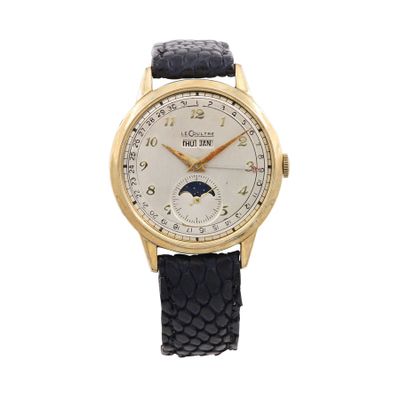a close up of a gold wrist watch with a white dial