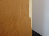 a close up of a wooden door with peeling paint on it