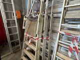 many ladders that are stacked up in a room