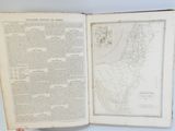 someone holding a book open to a map on a table