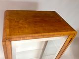 a small wooden table with a mirror on top of it
