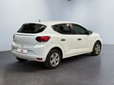 the back of a white car is parked in a room