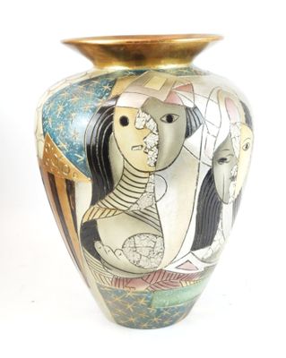 a vase with a painting on it sitting on a table