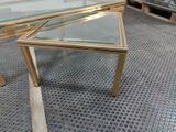 a glass table with a gold frame on it