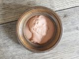 a close up of a jar of cream on a wooden table