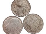 three british silver coins, one of which is a sovereign and one of which is a sovereign