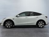 the tesla model y is parked in a white room