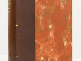 an old book with a brown cover and a red cover