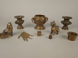 a lot of brass items that are on the table