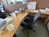 a desk with a chair and a computer on it