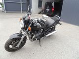 a black motorcycle parked in front of a building