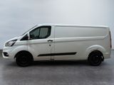 the white van is parked in a parking lot on a cloudy day