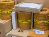 several rolls of rope are stacked on top of boxes in a warehouse