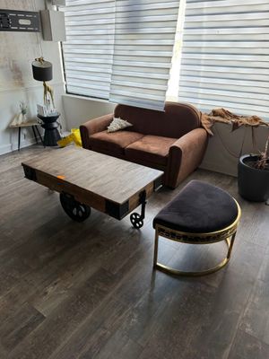 a living room with a couch, coffee table, and ottoman