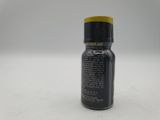 a close up of a bottle of black liquid on a white surface