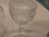 many glass dishes and cups on the table
