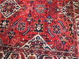 an image of a red rug with a blue and red design