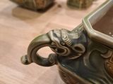 a vase that is sitting on a table with other vases in the background
