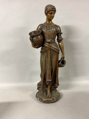 bronze statue of a woman holding a pot and a jug