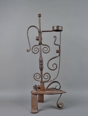 wrought iron candelab with candle holders on top of it